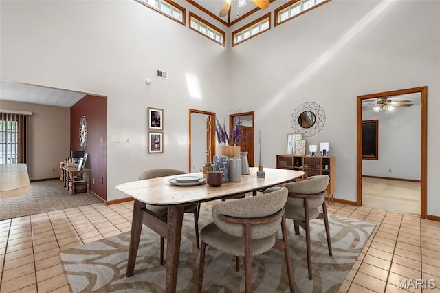 3581 Jarvis Rd, Hillsboro, MO 63050 - dining room with a ceiling fan, light tile patterned floors, a towering ceiling, and baseboards