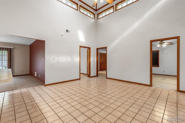3581 Jarvis Rd, Hillsboro, MO 63050 - unfurnished living room with a ceiling fan, a high ceiling, baseboards, and light tile patterned flooring