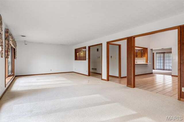 3581 Jarvis Rd, Hillsboro, MO 63050 - unfurnished living room with light colored carpet, baseboards, and light tile patterned flooring
