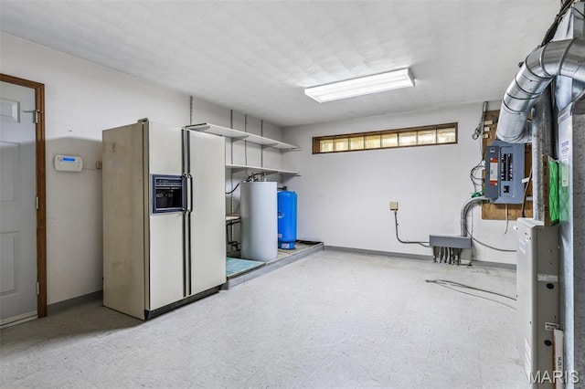 3581 Jarvis Rd, Hillsboro, MO 63050 - below grade area featuring white refrigerator with ice dispenser, gas water heater, tile patterned floors, a water pressure tank, and baseboards