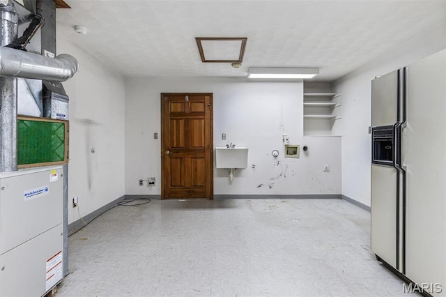 3581 Jarvis Rd, Hillsboro, MO 63050 - garage with white fridge with ice dispenser, baseboards, and a sink