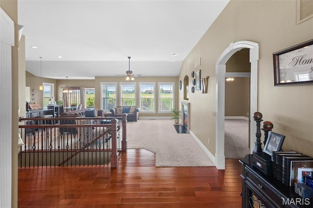 7048 Alston Ct, Edwardsville, IL 62025 - corridor with wood finished floors, arched walkways, baseboards, carpet floors, and an upstairs landing