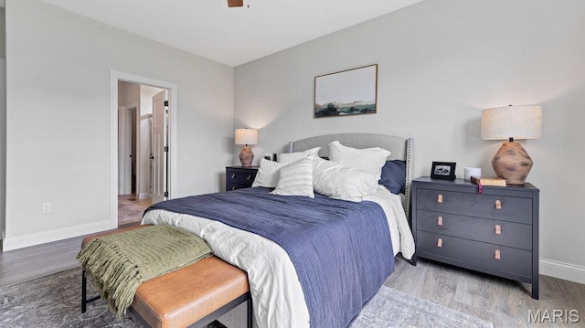 bedroom with wood finished floors and baseboards