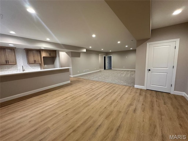 11906 Santino Ct, Creve Coeur, MO 63141 - finished below grade area featuring recessed lighting, baseboards, light wood-type flooring, and a sink