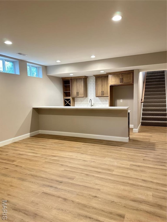 11906 Santino Ct, Creve Coeur, MO 63141 - unfurnished living room with recessed lighting, light wood-type flooring, a sink, baseboards, and stairway