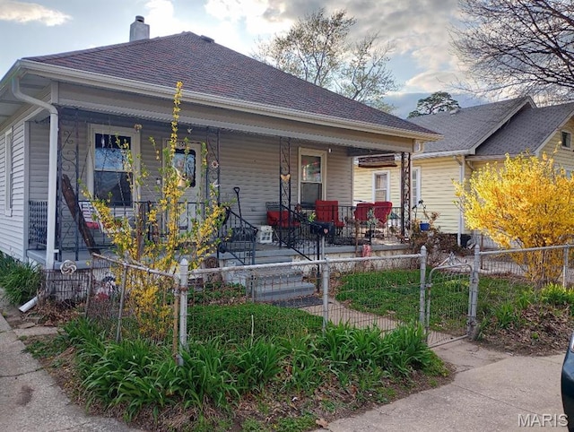 306 Kingshighway, East Alton, IL 62024 - view of front of property with covered porch, a fenced front yard, a chimney, and a gate
