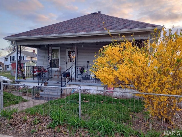 306 Kingshighway, East Alton, IL 62024 - view of front of property featuring a porch, a shingled roof, and a fenced front yard