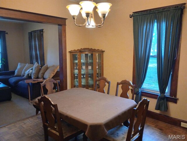 306 Kingshighway, East Alton, IL 62024 - dining room featuring a chandelier and baseboards