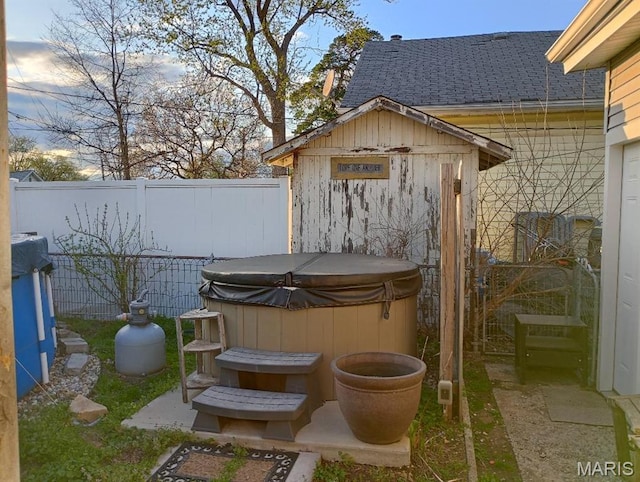 306 Kingshighway, East Alton, IL 62024 - view of outbuilding with a hot tub and fence