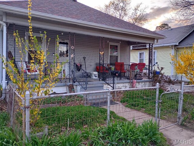 306 Kingshighway, East Alton, IL 62024 - property entrance with covered porch, fence, a gate, and a shingled roof