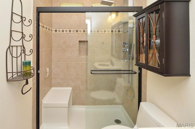 full bathroom featuring toilet and a stall shower