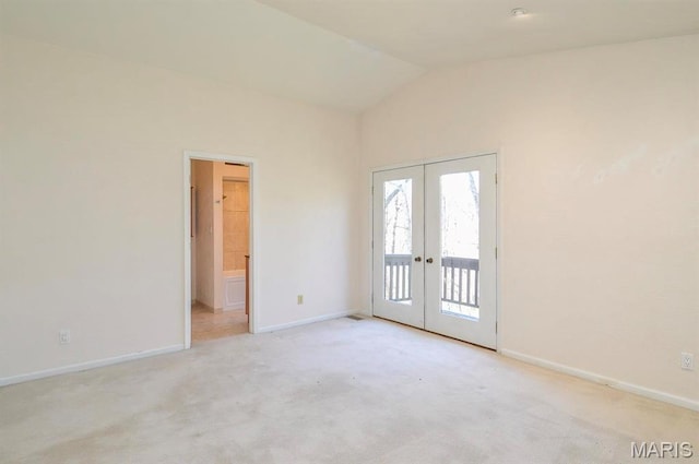 unfurnished room with french doors, baseboards, vaulted ceiling, and carpet