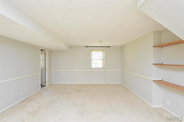 empty room featuring carpet and baseboards