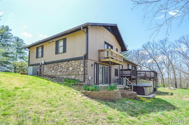 3019 Cedar Ridge Ln, Waterloo, IL 62298 - back of property with a hot tub, stone siding, a balcony, a yard, and a deck