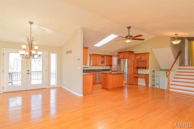3019 Cedar Ridge Ln, Waterloo, IL 62298 - kitchen with lofted ceiling, freestanding refrigerator, open floor plan, dark countertops, and brown cabinets