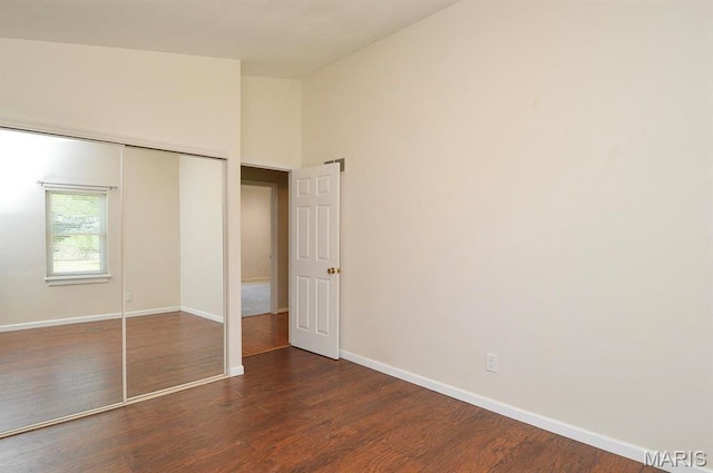 3019 Cedar Ridge Ln, Waterloo, IL 62298 - unfurnished bedroom with baseboards, dark wood-style flooring, and a closet