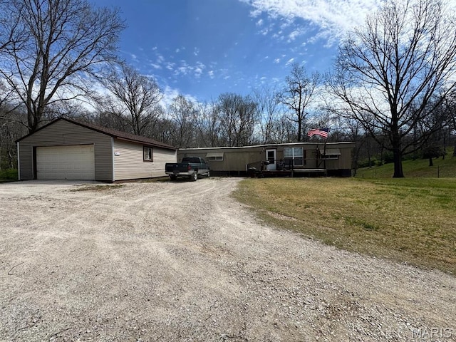 manufactured / mobile home featuring a garage and an outdoor structure