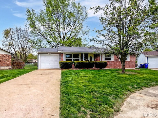 2331 Battlefield Dr, Florissant, MO 63031 - view of front facade featuring brick siding, a garage, and driveway