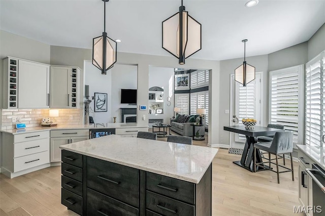 500 Overlook Terrace Court, Eureka, MO 63025 - kitchen with healthy amount of natural light, light wood-style flooring, decorative backsplash, a kitchen island, and recessed lighting