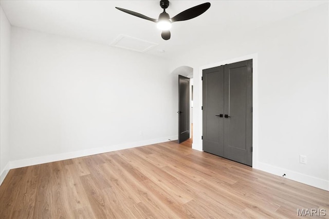 8100 Delmar Blvd Unit 2W, Saint Louis, MO 63130 - empty room with light wood-style flooring, baseboards, ceiling fan, and arched walkways