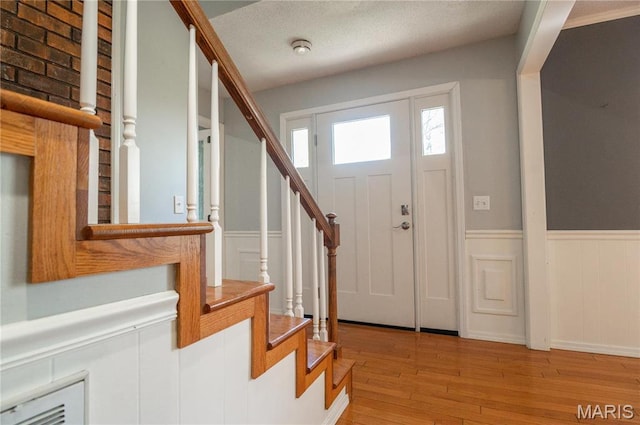 16747 Chalk Bluff Trl, Dexter, MO 63841 - foyer entrance with stairway, light wood-style floors, and wainscoting