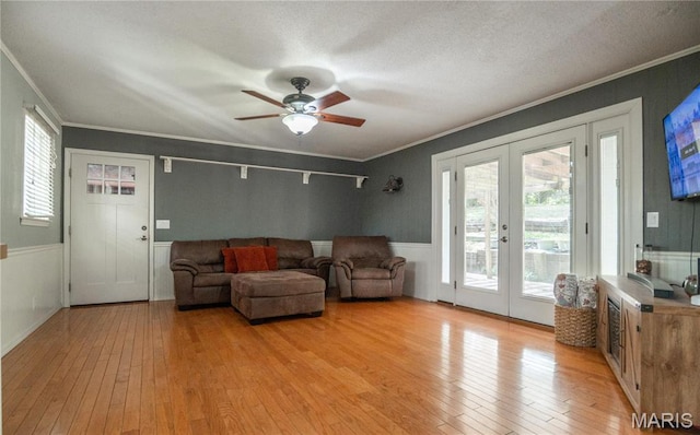 16747 Chalk Bluff Trl, Dexter, MO 63841 - living area featuring french doors, crown molding, light wood-type flooring, plenty of natural light, and ceiling fan