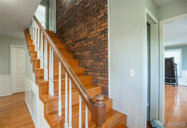 16747 Chalk Bluff Trl, Dexter, MO 63841 - staircase with wood finished floors and brick wall