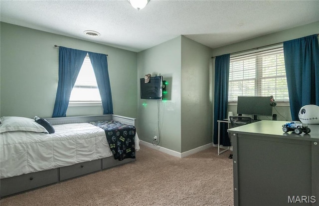 16747 Chalk Bluff Trl, Dexter, MO 63841 - bedroom featuring a textured ceiling, light carpet, baseboards, and a desk