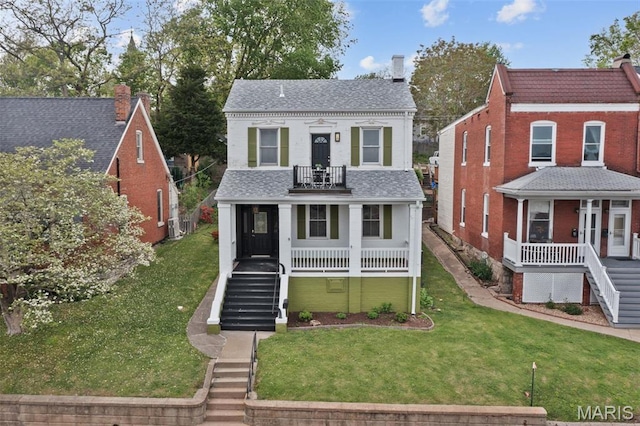 view of front of home with stairway, a porch, and a balcony
