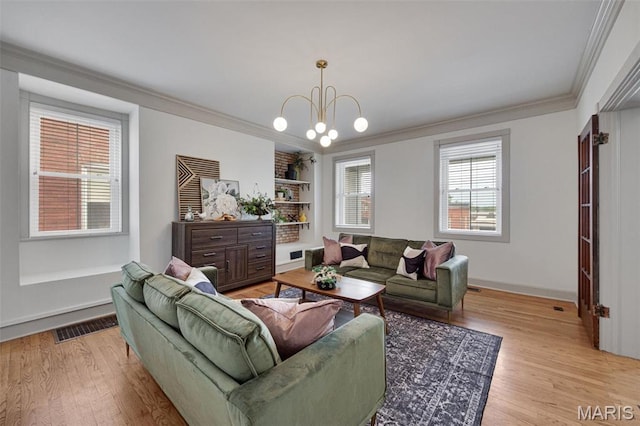 living room featuring wood finished floors, crown molding, a chandelier, and baseboards