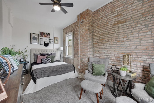 bedroom featuring brick wall, carpet, and a ceiling fan