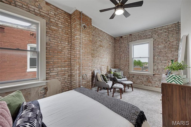 bedroom with brick wall, carpet, and baseboards
