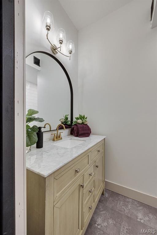 bathroom with vanity and baseboards