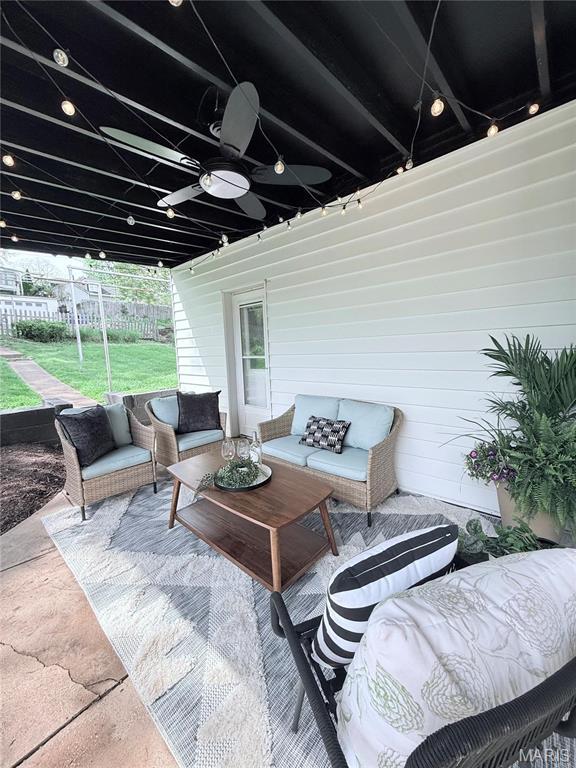 sunroom / solarium with ceiling fan and an outdoor hangout area