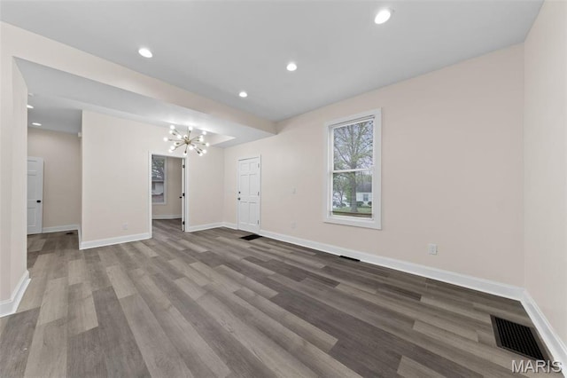 236 Georgia Ave, Saint Louis, MO 63135 - unfurnished living room featuring a chandelier, wood finished floors, baseboards, and recessed lighting