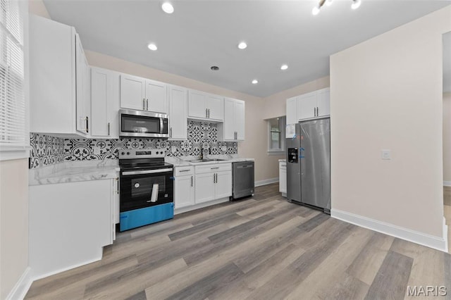 236 Georgia Ave, Saint Louis, MO 63135 - kitchen featuring appliances with stainless steel finishes, a sink, light countertops, white cabinets, and recessed lighting