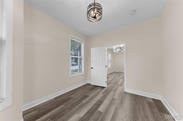 236 Georgia Ave, Saint Louis, MO 63135 - spare room featuring a chandelier, wood finished floors, baseboards, and a smoke detector
