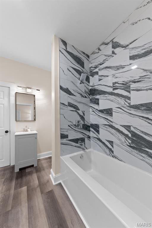 236 Georgia Ave, Saint Louis, MO 63135 - bathroom featuring vanity, shower / tub combination, wood finished floors, and baseboards