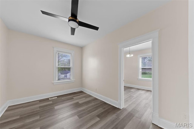 236 Georgia Ave, Saint Louis, MO 63135 - spare room with dark wood-style flooring, baseboards, and ceiling fan