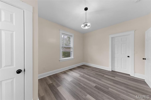 236 Georgia Ave, Saint Louis, MO 63135 - unfurnished room featuring wood finished floors, baseboards, and a chandelier