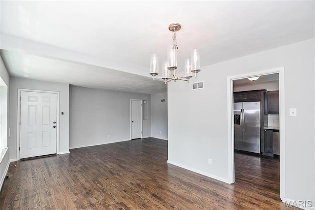 7219 Dartmouth Ave, Saint Louis, MO 63130 - unfurnished room with a chandelier, dark wood-style flooring, and baseboards