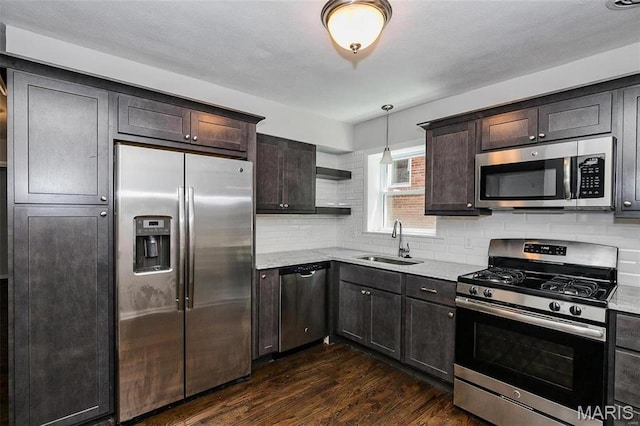 7219 Dartmouth Ave, Saint Louis, MO 63130 - kitchen featuring stainless steel appliances, a sink, dark wood-type flooring, open shelves, and decorative backsplash