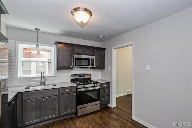 7219 Dartmouth Ave, Saint Louis, MO 63130 - kitchen featuring appliances with stainless steel finishes, a sink, baseboards, and light countertops