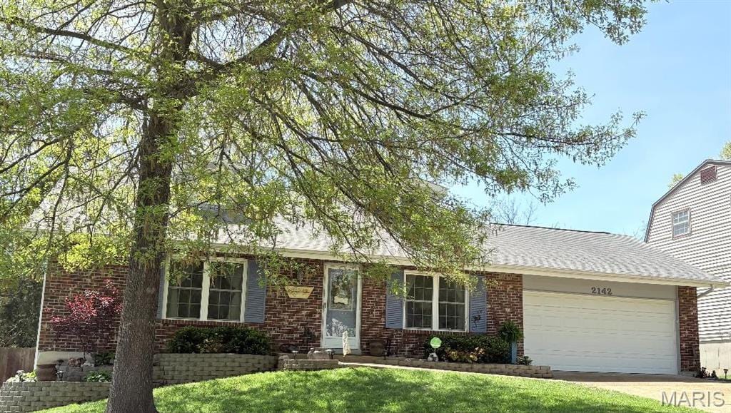2142 Catlin Ct, Barnhart, MO 63012 - view of front facade featuring a garage, brick siding, a front yard, and concrete driveway