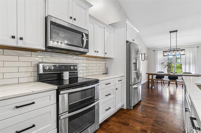 105 Shepherd Mountain Rd, Farmington, MO 63640 - kitchen with appliances with stainless steel finishes, white cabinetry, light stone counters, dark wood-type flooring, and tasteful backsplash