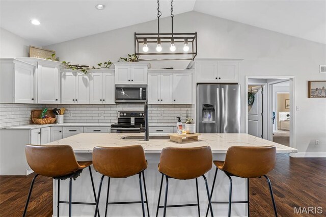 105 Shepherd Mountain Rd, Farmington, MO 63640 - kitchen with appliances with stainless steel finishes, white cabinetry, decorative light fixtures, an island with sink, and decorative backsplash