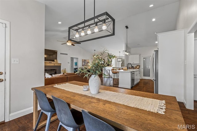 105 Shepherd Mountain Rd, Farmington, MO 63640 - dining space featuring ceiling fan, lofted ceiling, a fireplace, dark wood-style flooring, and recessed lighting