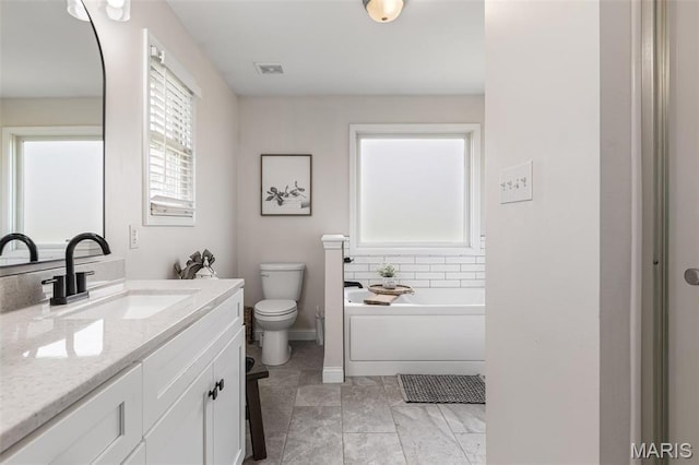 105 Shepherd Mountain Rd, Farmington, MO 63640 - full bath with toilet, vanity, a garden tub, and baseboards