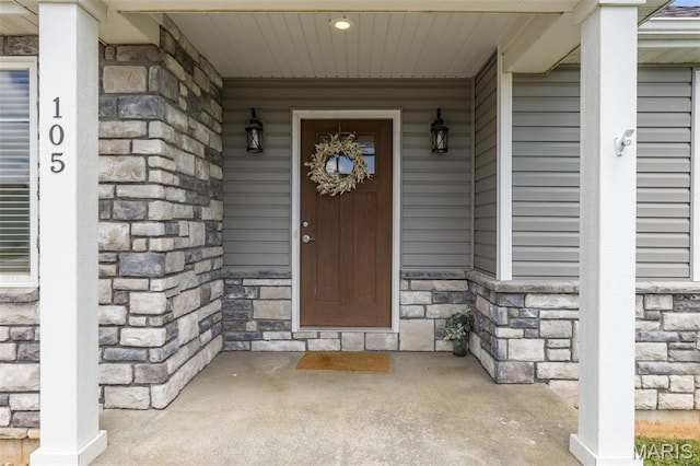 105 Shepherd Mountain Rd, Farmington, MO 63640 - view of exterior entry with stone siding and a porch