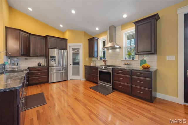 409 Pawnee Dr, Irondale, MO 63648 - kitchen featuring wall chimney range hood, appliances with stainless steel finishes, a sink, dark brown cabinets, and lofted ceiling